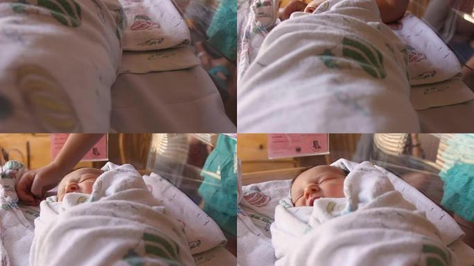 一个大姐姐在医院的婴儿床里亲吻她的新生婴儿