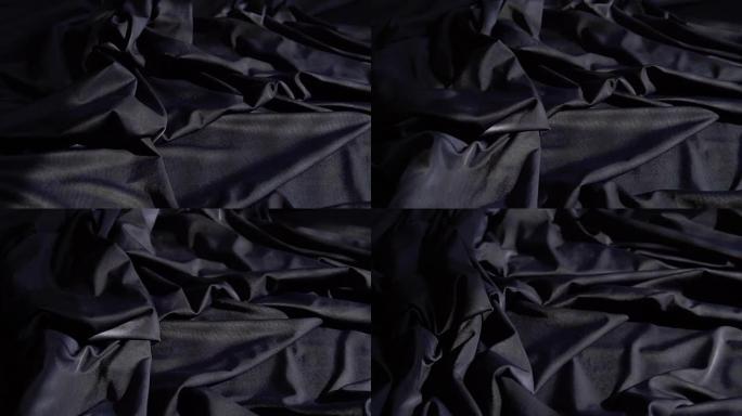 背景纹理柔软的黑色织物纺织材料反向移动。