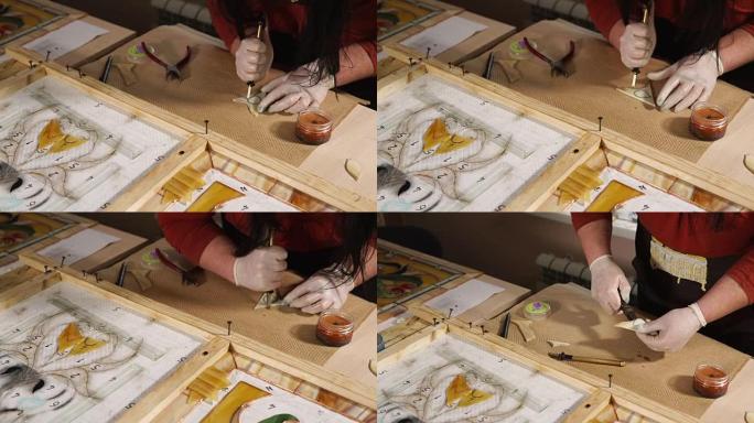 大师正在切割一小块玻璃，用于制作装饰板的图案