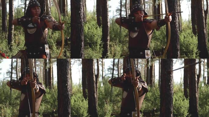 有东方外貌的弓箭手正在森林中射箭