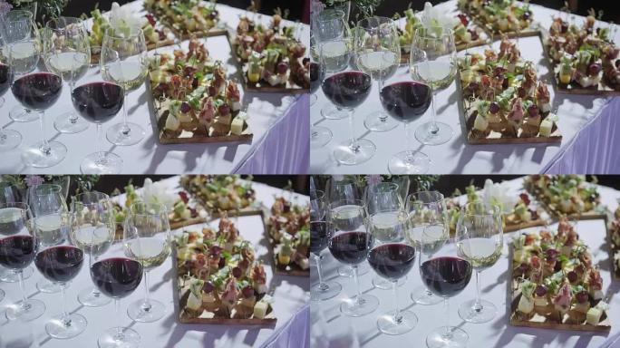 Furshet。桌面装满了一杯葡萄酒，背景是小点心和开胃菜。香槟泡泡