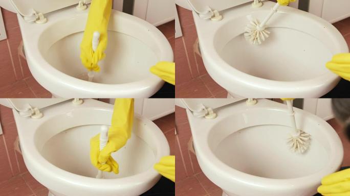 妇女的双手特写黄色橡胶手套用刷子洗马桶。