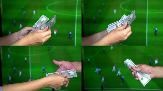 赌球理念:手数钱给另一个人，就像输钱一样。足球赌博的概念。以足球比赛为背景的电视屏幕。