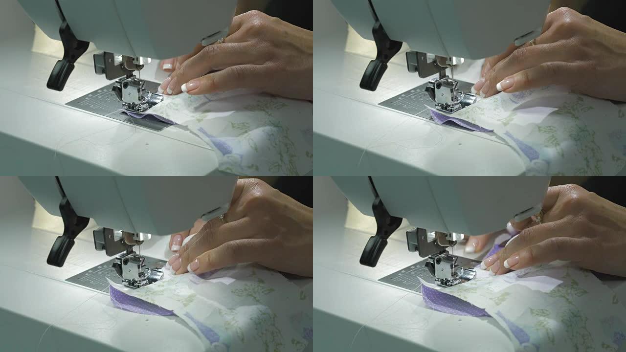 缝纫机缝制两种织物。特写。女性双手控制操作。