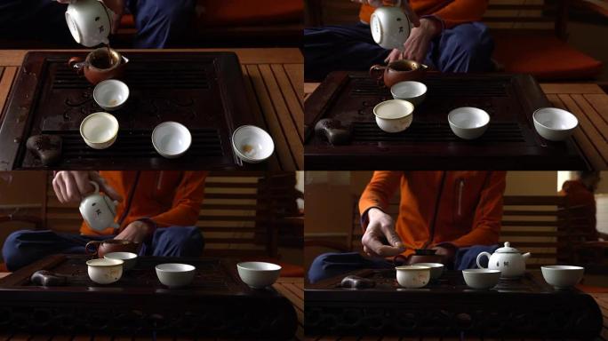在中国传统茶道上，男人在茶壶里倒普洱茶。一套饮茶设备
