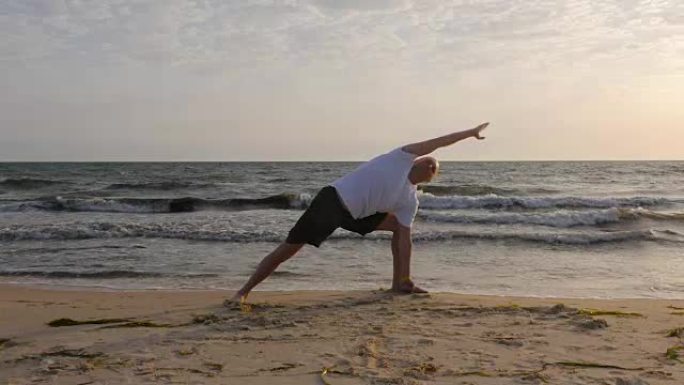 日出时在海边练习瑜伽的运动员