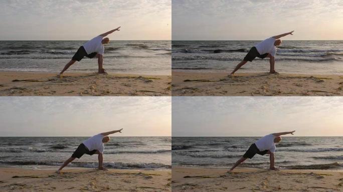 日出时在海边练习瑜伽的运动员