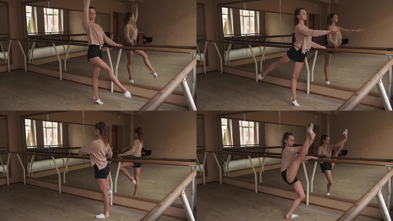 灵活的年轻女舞者在工作室里伸展双腿