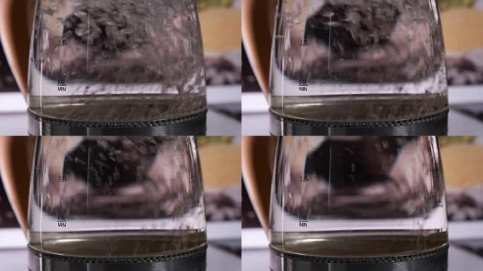 在玻璃电热水壶中煮沸的水。宏。特写镜头。
