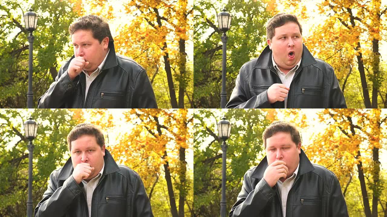 肖像男子在秋季公园咳嗽