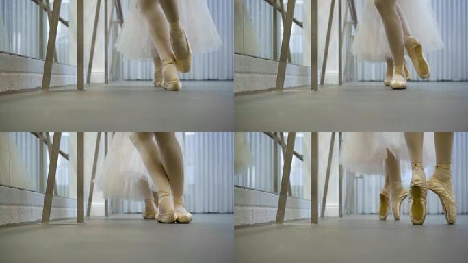 两名芭蕾舞演员在室内的芭蕾舞工作室里站着脚趾