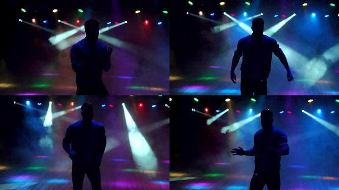一个现代年轻人在夜总会的黑暗中跳舞