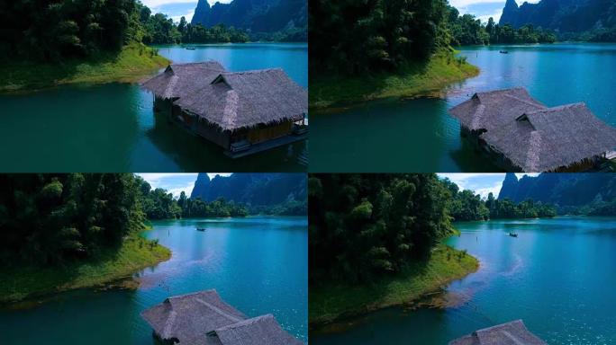 空中: 湖面上有茅草屋顶的房子，旁边有一艘船。