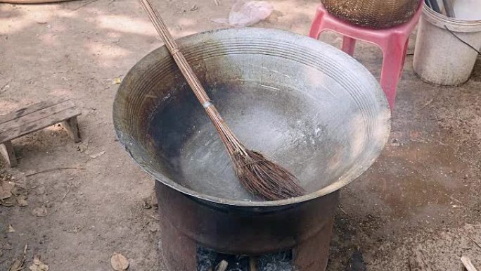 close up of a man washing a hot wok cooking with a