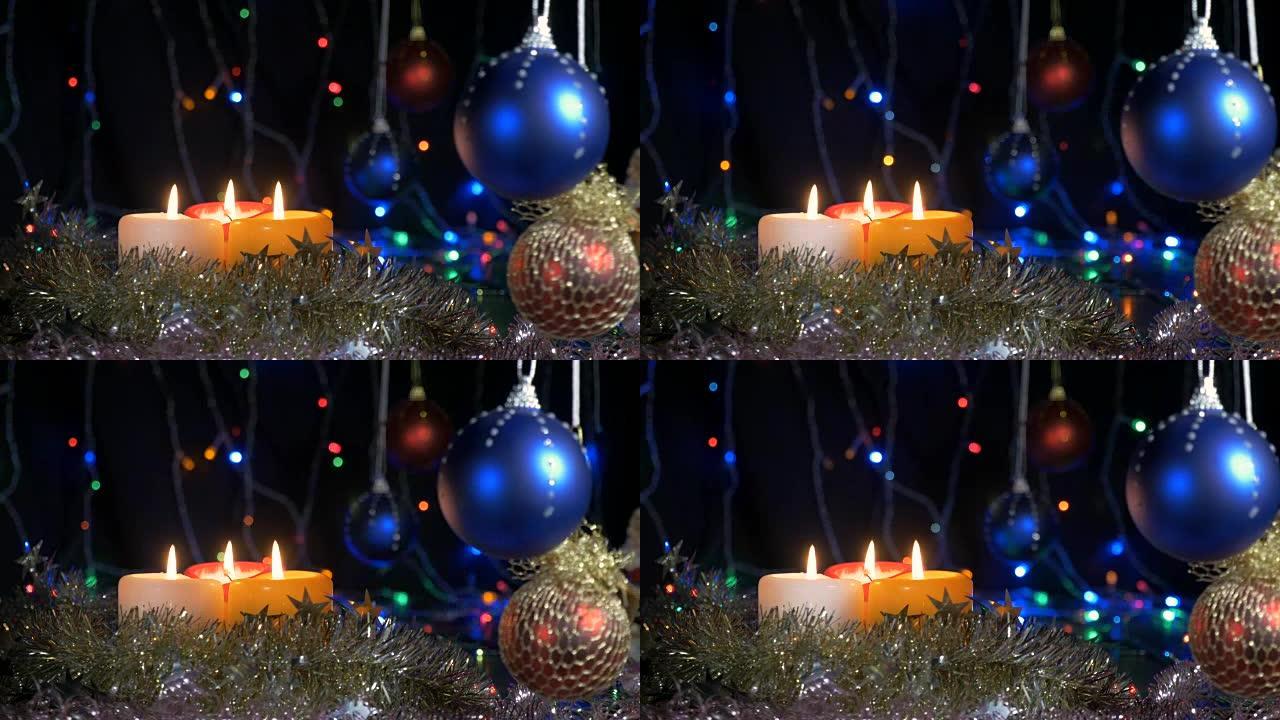 新年和圣诞装饰品。燃烧蜡烛。闪光花环。背景模糊。