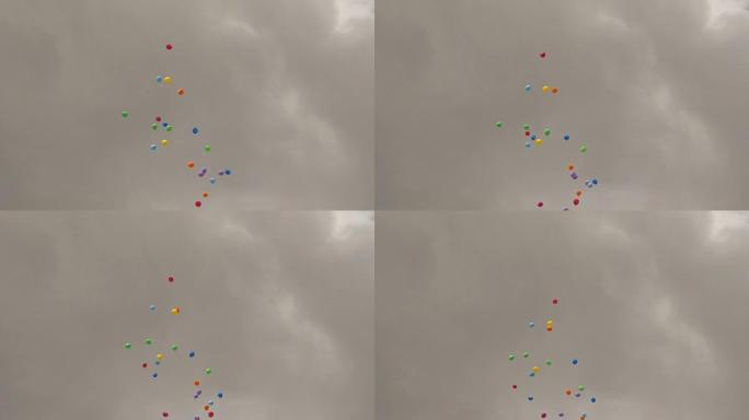 彩色气球在灰色的天空背景下飞翔