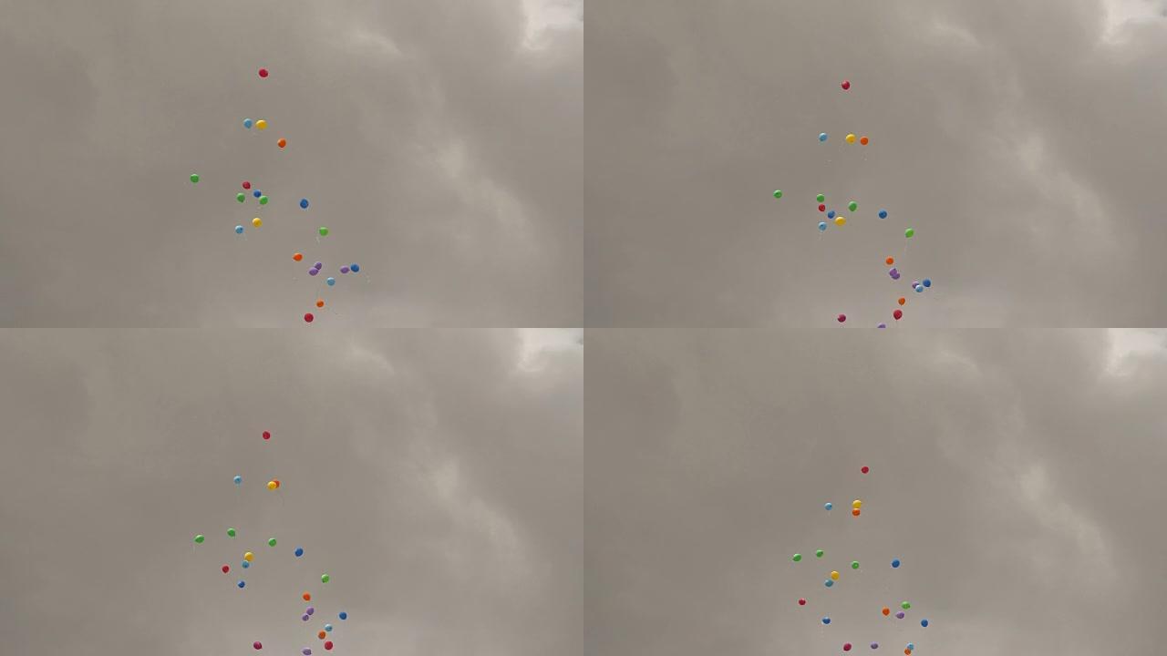 彩色气球在灰色的天空背景下飞翔