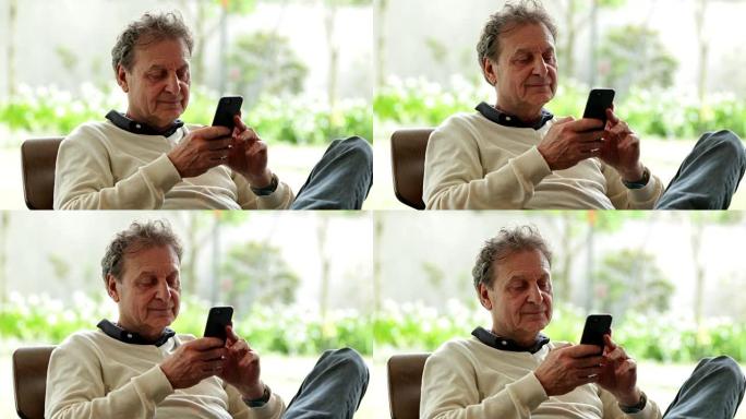 与手机智能手机技术交流的人。老年人使用手机以4k 60fps与工作和家人互动和交流