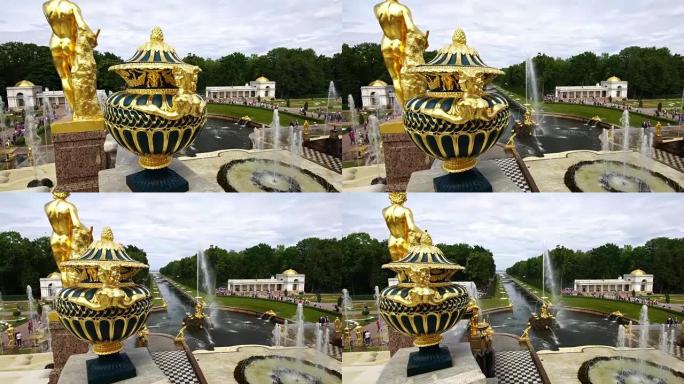 在俄罗斯圣彼得堡彼得霍夫大皇宫公园的喷泉，雕塑和花瓶的跟踪镜头