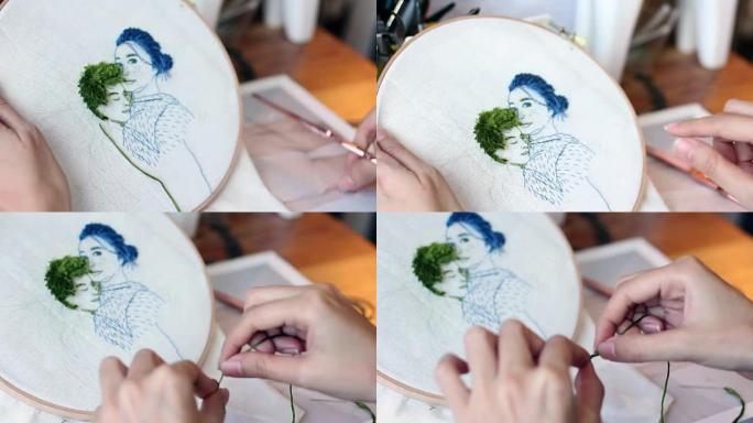 手工缝合针和线，为情侣肖像制作刺绣艺术品。