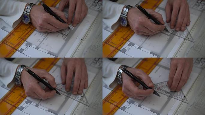 工程师在工作时用铅笔和尺子绘制平面图、图表