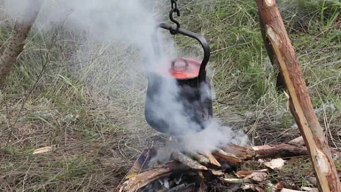 Preparing food on campfire in wild camping