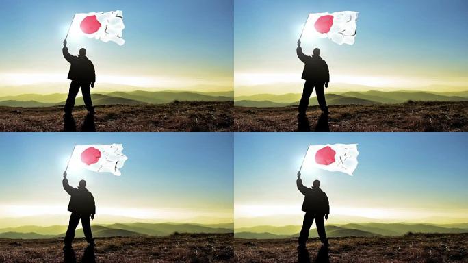 成功的剪影男子获胜者在山顶上挥舞着日本国旗，4k电影院