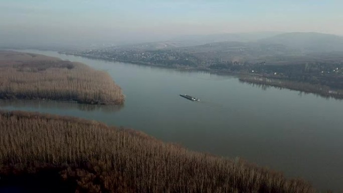 Cargo transport ship on a wide river. Aerial view.