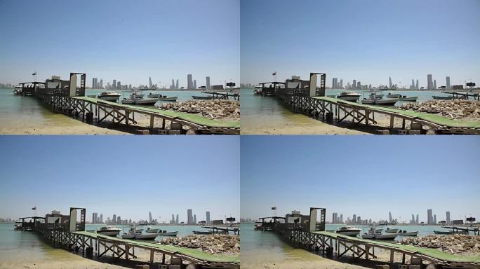 巴林。渔民的房子和船。麦纳麦天际线