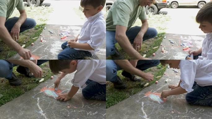 父子俩一起在人行道上用粉笔画画