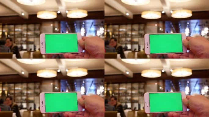 Motion of man holding green screen phone with blur