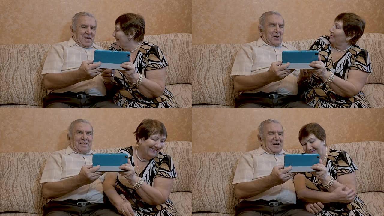 一对成年夫妇使用平板电脑，他们坐在沙发上