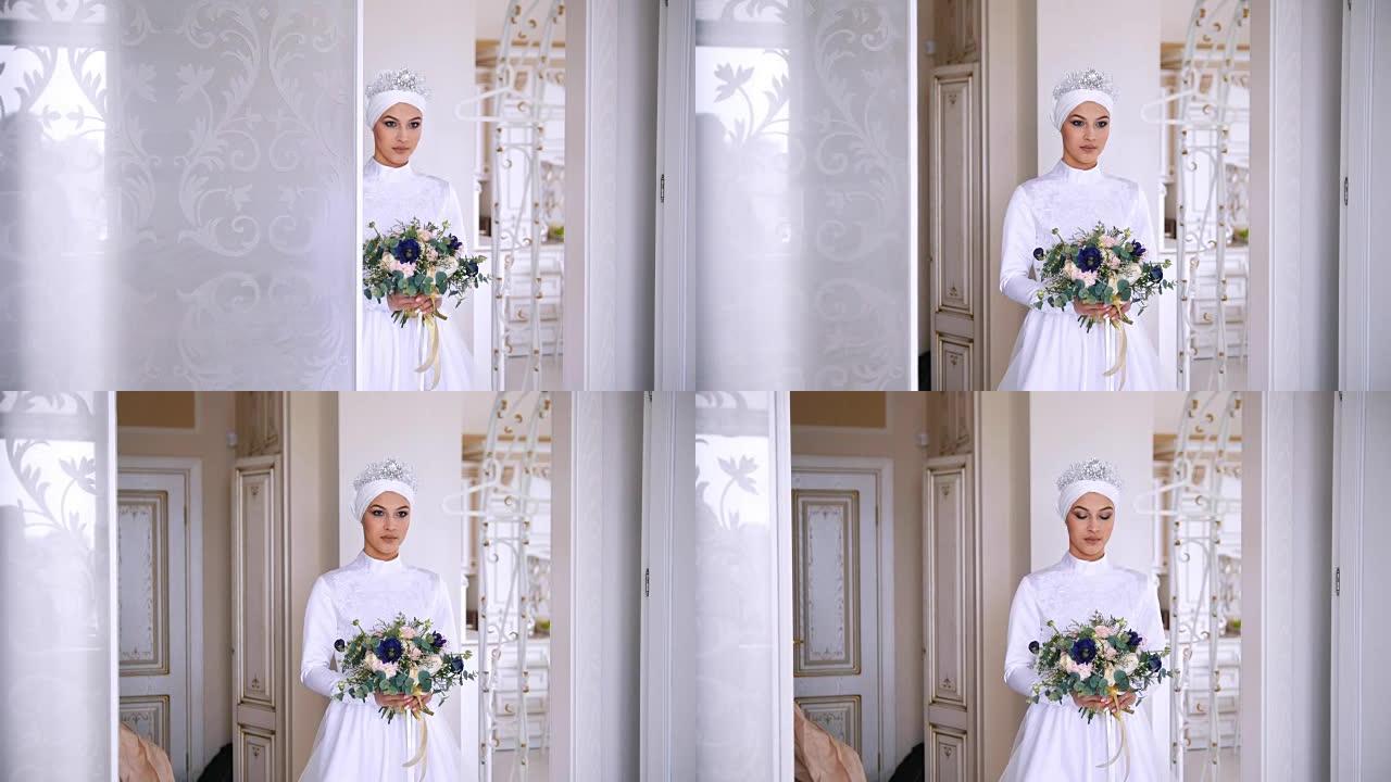 美丽的穆斯林新娘穿着婚纱，工作室里有新娘头饰