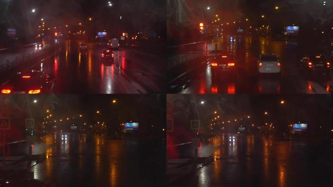 夜路。从赛道上的汽车上射击。汽车向前行驶。下雨，落在左玻璃上。从双层巴士上射击。4л
