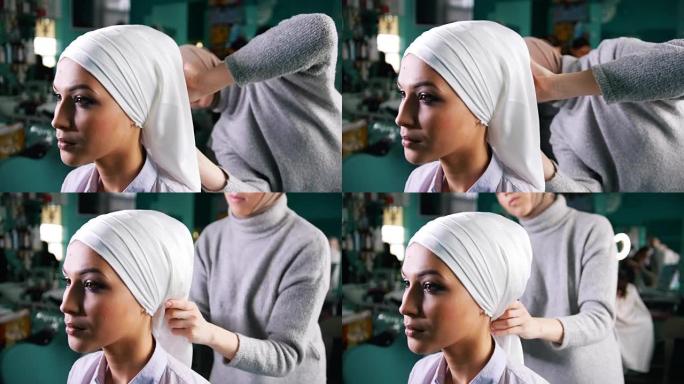 穆斯林妇女为迷人的新娘绑上伊斯兰头巾