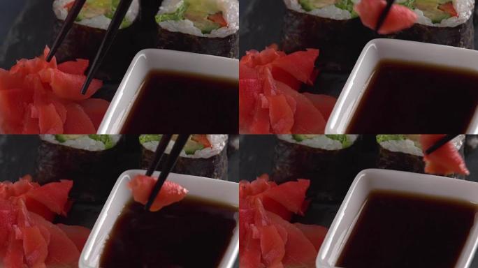 用筷子将寿司浸入酱油中，日本料理