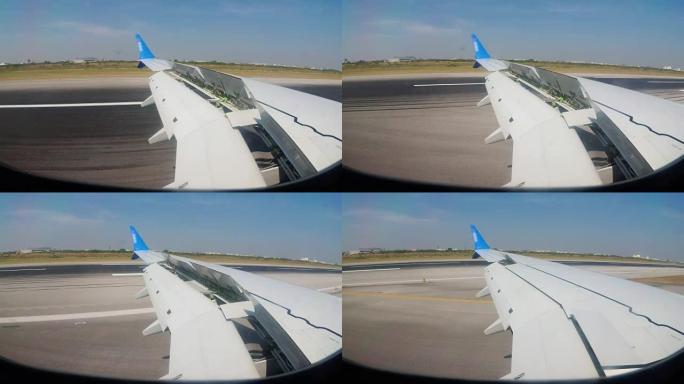 从曼谷机场沿跑道飞行的飞机机翼上的窗户看