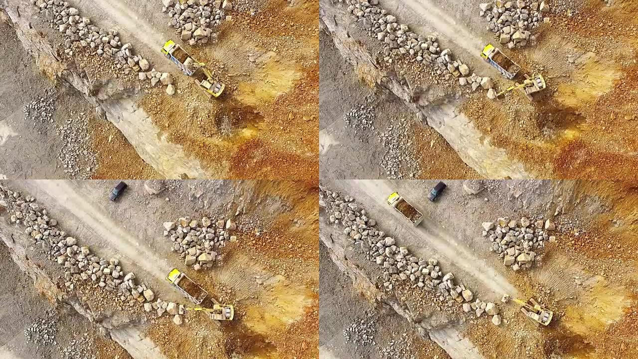 无人驾驶飞机飞越采石场的挖掘机。