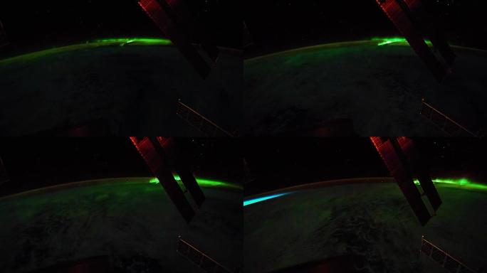 在地球北极上方看到的明亮的绿色极光。前景中可以看到国际空间站的太阳能电池板。剧照由美国宇航局约翰逊航