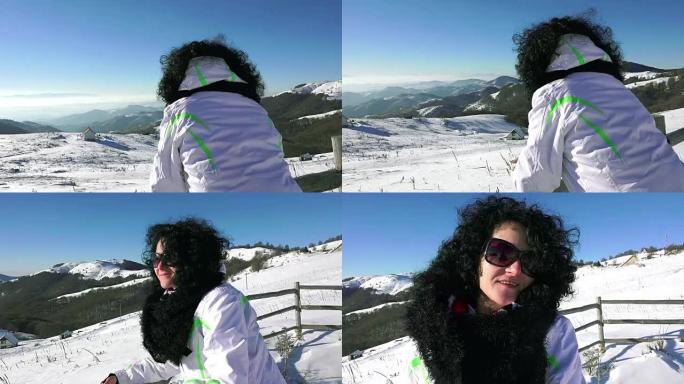 快乐的女人面对镜头，享受冬日。高山雪景，uhd steadycam股票视频