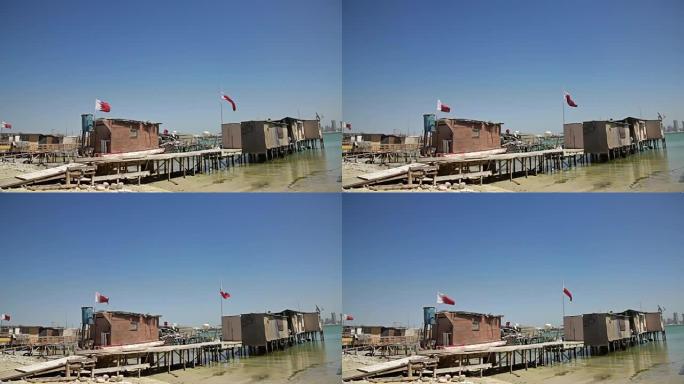巴林。渔民的房子和船。旗帜和麦纳麦天际线