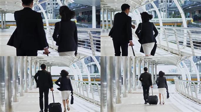 拖着行李走路的同事匆忙通过