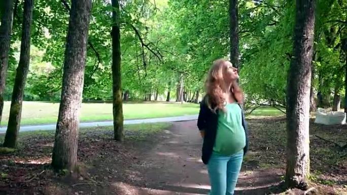 孕妇准妈妈走过公园树巷