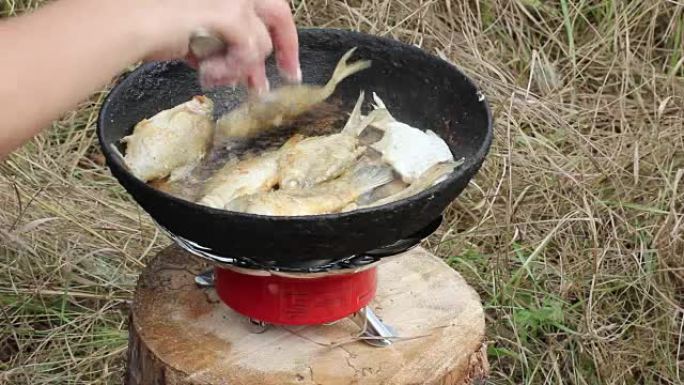 Fried fish on a pan bonfire