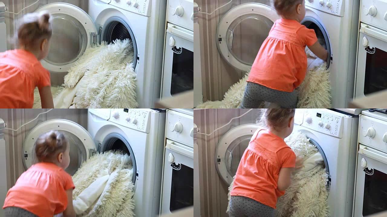 有趣可爱的小女孩把脏东西放在洗衣机里。婴儿和洗衣房
