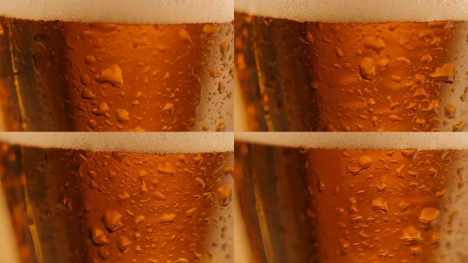 玻璃杯上滴着新鲜啤酒的旋转细节