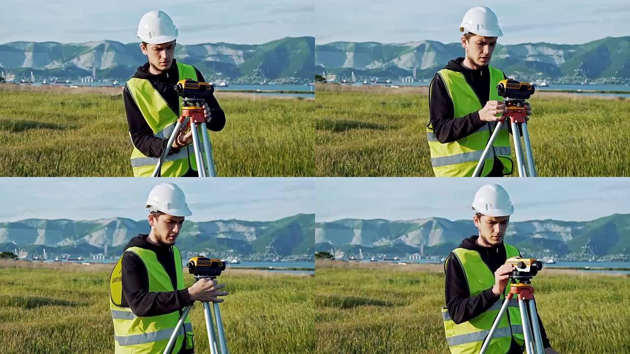 测量员工程师正在施工现场测量水平。大地测量仪确保在进行大型建筑项目之前进行精确的测量。景观设计的概念