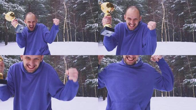 手里拿着奖品的快乐男人在冬天的森林里跳起来欢喜。体育比赛中的胜利。