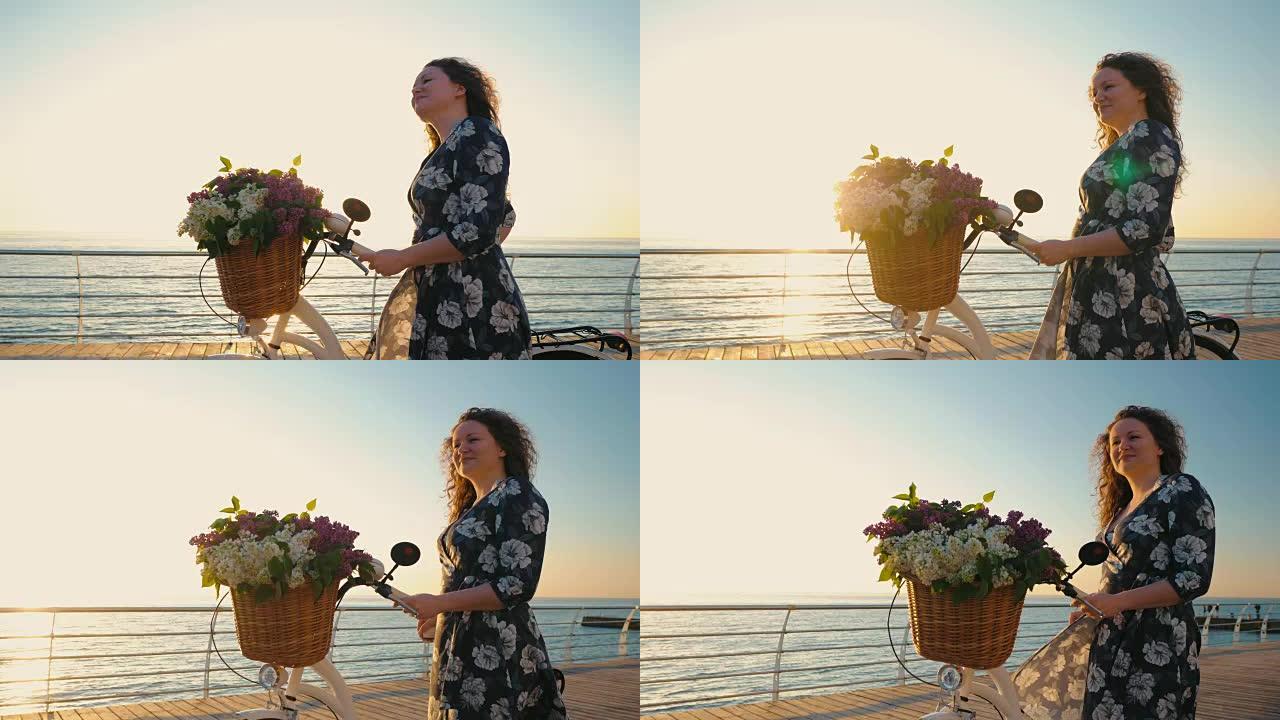 成年可爱的卷发女人穿着复古白色自行车连衣裙，在日出或日落时站在海边。假期旅行时间。浪漫的场景。女性生
