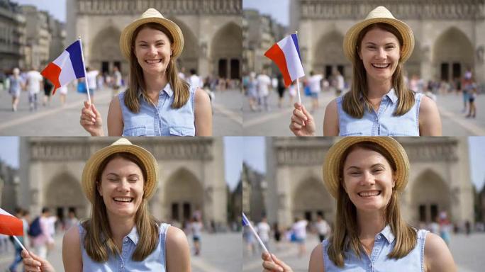 快乐的女孩享受假期。戴着帽子的游客站在巴黎圣母院附近。挥舞法国国旗